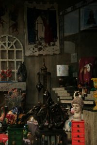 A cozy antique shop filled with eclectic sculptures and vintage decor, conveying a warm atmosphere.