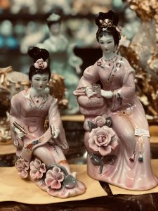 Traditional Chinese porcelain figurines with intricate details and pastel colors.