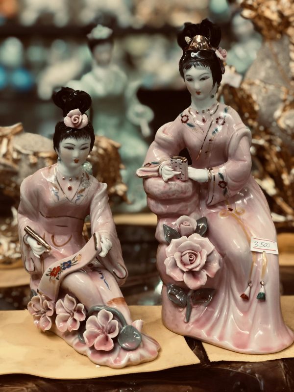 Traditional Chinese porcelain figurines with intricate details and pastel colors.